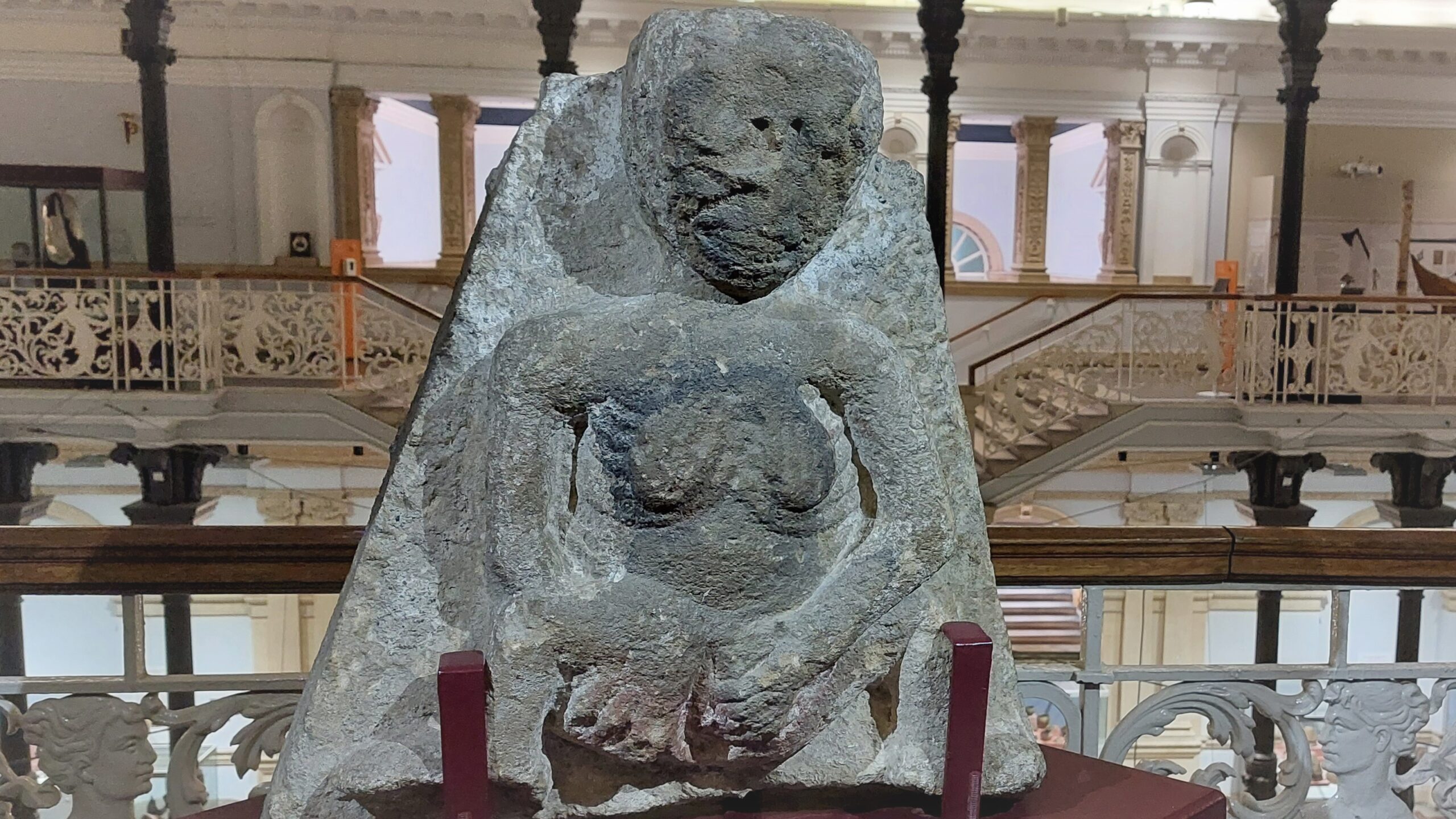 The Clonmel Sheela na Gog on display in the National Museum. The gallery and railings can be seen in the background