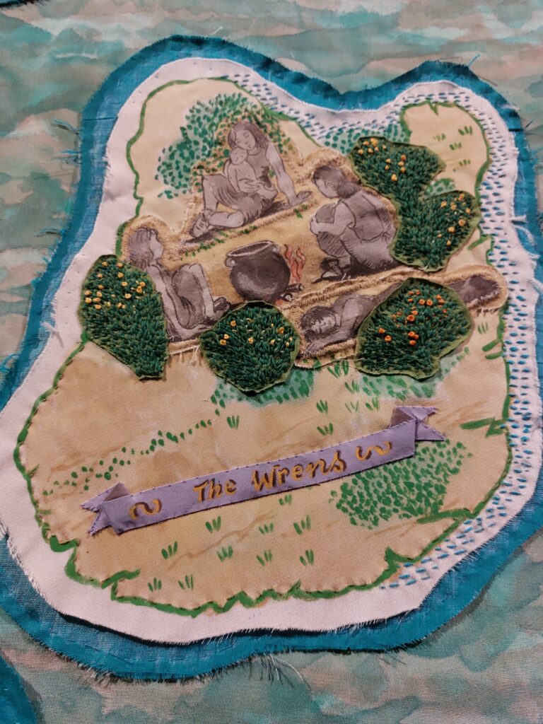 Detail from The Map by Alice Maher and Rachel Fallon, features a hand stitched island with the Curragh Wrens women sitting between furze bushes