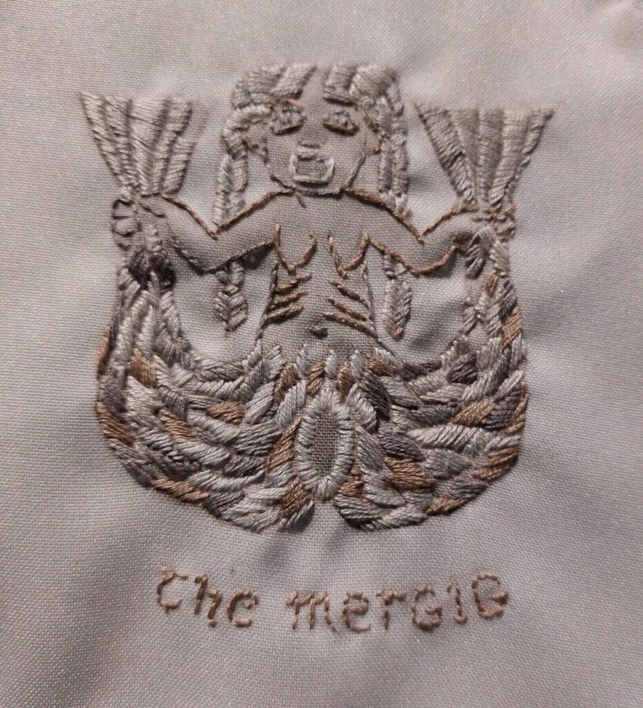 embroidered panel of a Mergig - a cross between a mermaid and a sheela-na-gig