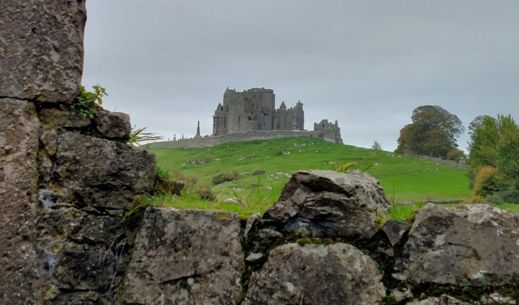 view of the Rock of Cashel, a medieval cathedral on a hill, from the ruins of Hore Abbey in Co. Tipperary