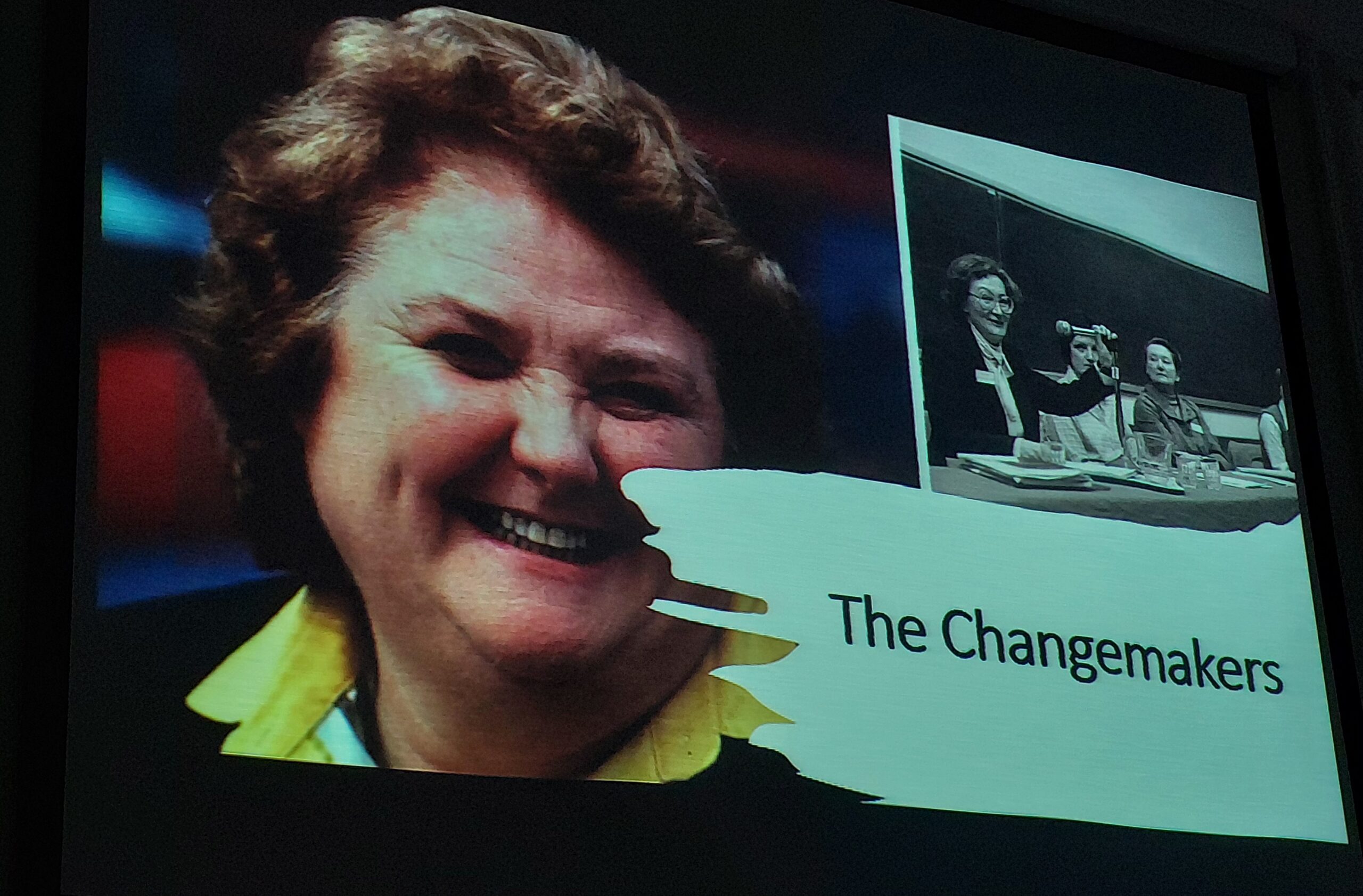 Slide featuring a photo of Monica Barnes and an inset of women at a meeting from a presentation entitled The Changemakers by Clodagh Finn