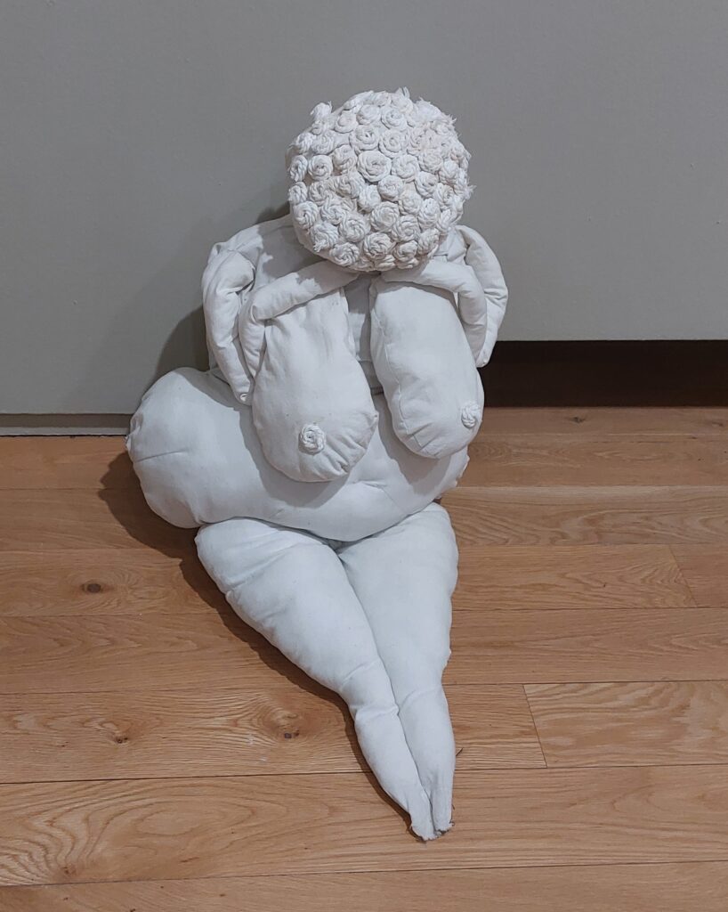 A large, stuffed fabric 'doll' depicting a nude woman by artisits Na Cailleacha