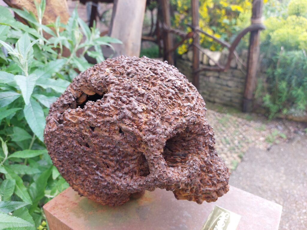 A sculpture of a skull made of copper coins