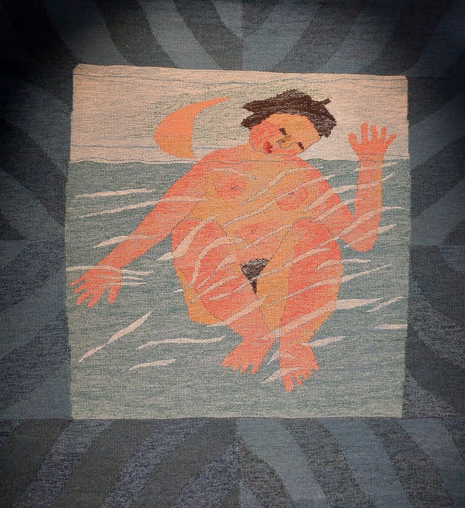 Textile artwork by Hildur Hakonardottir showing a naked woman in the sea with a half moon in the sky
