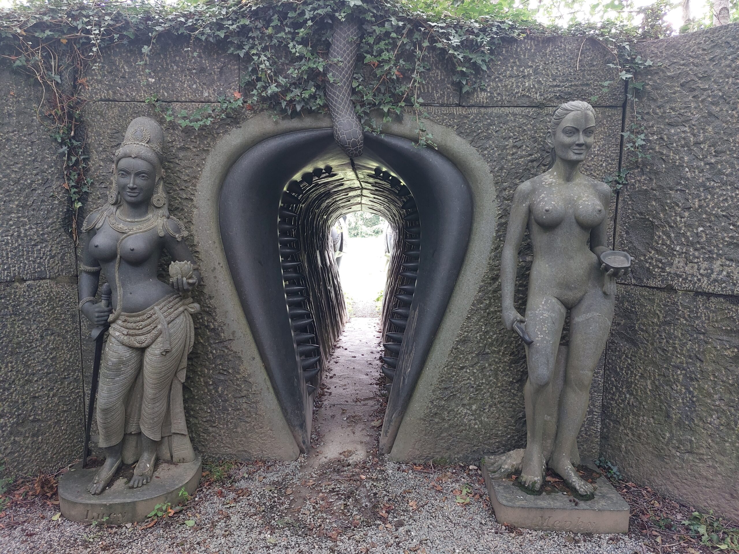 Sculpture of a vagina dentata flanked by two female figures, at Victor's Way, Wicklow