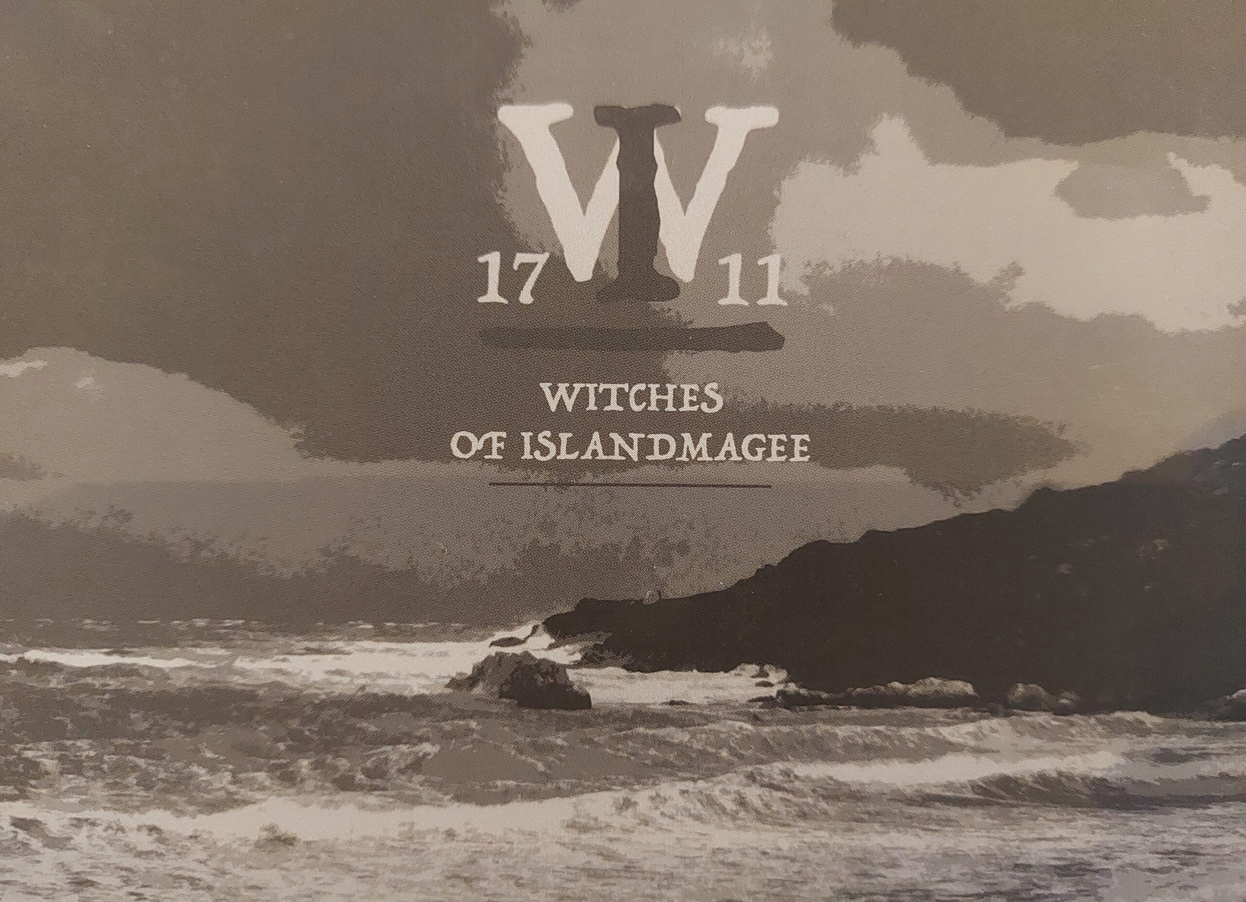 postcard with black and white image of the Antrim coastline with the logo of the W1711 Witches of Islandmagee exhibition.